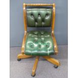 Green Chesterfield style desk or office chair raised on castors