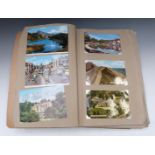 Album of postcards to include Devon, Swanage, Cornwall, Lake Orta, Lake District and Ireland