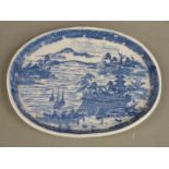 A 19thC Chinese oval shallow dish decorated with ships and buildings and impressed seal mark to