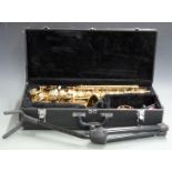 Earlham Alto saxophone with accessories and stand, in hard fitted case