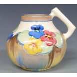 Clarice Cliff for Newport Pottery Bizarre jug decorated in the Pansies pattern, shape no. 634,
