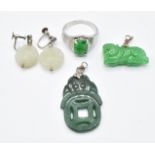A silver ring set with jadeite, a pair of earrings set with jade and paste and two jadeite pendants