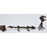 Three Japanese bronzes, a dragon, plant and creature, 15.5 x 4cm