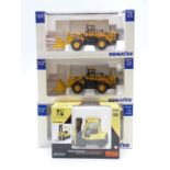 Four diecast model commercial vehicles, three Komatsu comprising two WA600 and PC450LCD, and Norscot
