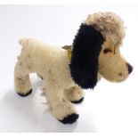 A vintage French straw filled Teddy bear dog with growler, leather collar and bell, 53cm long.