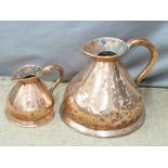 Two Victorian copper measuring jugs with VR ciphers ' 1/2 Gallon' and '2 Gallon', tallest 33cm