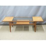 A retro / mid century modern glazed coffee table with undershelf, W136 x D51 x H43cm