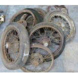 Six Austin Seven wheels comprising an early 6 inch braked example, three examples with Austin script