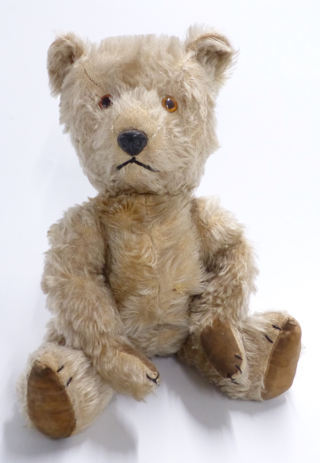 Vintage straw filled Teddy bear with blonde mohair, disc joints, felt pads and stitched features,