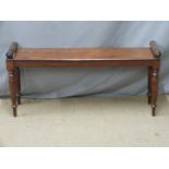 A 19thC (probably late Georgian) mahogany window seat with turned rests, raised on slim stepped