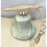 A large 19thC bronze bell attached to a cast metal suspension bar with rope pull attachment. We