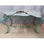 Victorian cast iron conservatory/ garden table of serpentine shape raised on ornate scrolling legs.