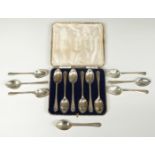 Cased set of six hallmarked silver Walker & Hall golf spoons together with a further set of six