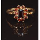 A 9ct gold ring set with garnets, size R, 1.7g