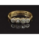 An 18ct gold ring set with five diamonds in a platinum setting, size L, 2g