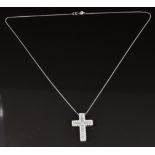 An 18ct white gold cross set with a princess cut diamond, baguette cut diamonds and round cut