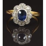 An 18ct gold ring set with an oval cushion cut sapphire of approximately 0.5ct surrounded by