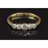 An 18ct gold ring set with five diamonds in a platinum setting, size K, 1.7g