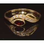 A yellow metal ring set with a garnet and cubic zirconia, marked 800, size R, 1.9g