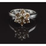 An 18ct white gold ring set with a cluster of round cut champagne diamonds, total approximately  0.