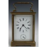 Brass carriage clock with alarm function, stamped ACG inside with Roman numerals to the enamelled