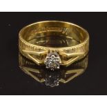 An 18ct gold ring set with a diamond, size M, 3.7g