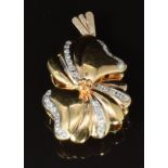 An 18ct gold pendant in the form of a stylised flower set with diamonds, 6.4g