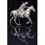 A 9ct gold pendant in the form of a polo player, 3.2 x 3cm, 8.9g
