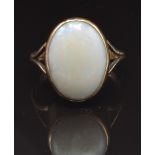 A 9ct gold ring set with a white opal cabochon, size R, 3.9g
