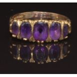 A 9ct gold ring set with five oval cut amethysts, size P, 2.9g