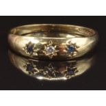 A 9ct gold ring set with a diamond and two sapphires in star settings, size P, 1.7g