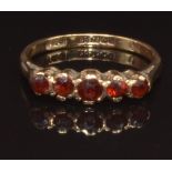 A 9ct gold ring set with garnets, size K, 1.7g