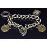 A bracelet with charms comprising two 1910 half gold sovereigns, a 9ct gold charm set with a 10