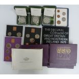 Three cased silver Royal Mint commemorative coins with certificates, together with ten UK proof sets