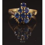 A yellow metal ring set with eight round cut sapphires, size O, 2.2g