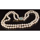 A double strand necklace of cultured pearls, the 9ct gold clasp set with turquoise and pearls