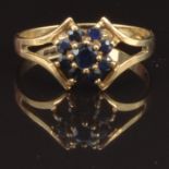 A 9ct gold ring set with sapphires in a cluster, size L, 1.4g