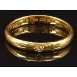 A 22ct gold wedding band/ ring set with a diamond in a star setting, Birmingham 1920, size S, 3.8g