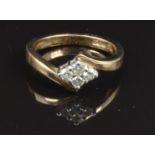 A 9ct gold ring set with four diamonds, size K, 3g