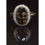 A 9ct gold ring set with smoky quartz surrounded by diamonds, size U, 4.3g