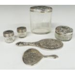 Four hallmarked silver lidded cut glass dressing table pots and two novelty miniature dressing table