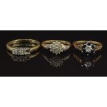 Three 9ct gold rings including one set with a diamond and sapphires, another set with a cluster of