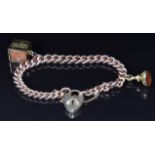 A 9ct rose gold bracelet with a 9ct gold ten shilling note charm and a Victorian fob set with agate,