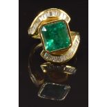 An 18ct gold ring set with a natural Colombian apple green emerald of approximately 5ct and 34