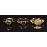 Three 9ct gold rings, one set with a heart cut garnet, 4.1g