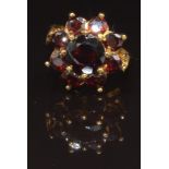 A 9ct gold ring set with a cluster of garnets, size L, 4.7g