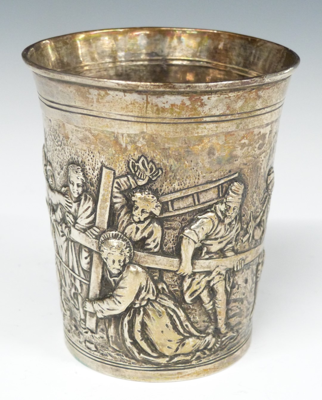 Continental white metal beaker with embossed scene of Christ carrying the cross, height 8.5cm,