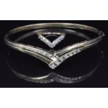 A 9ct gold bangle set with diamonds in a V shape and a similar ring, 9.4g