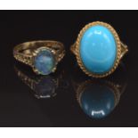 A 9ct gold ring set with a faux turquoise cabochon, size O, and a 9ct gold ring set with an opal