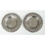 Pair of Egyptian white metal pin trays with embossed floral borders, diameter 9.5cm, weight 98g